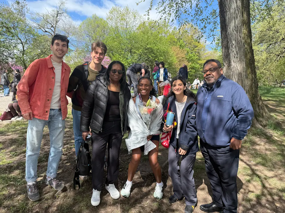Group of people smiling outdoors in park.