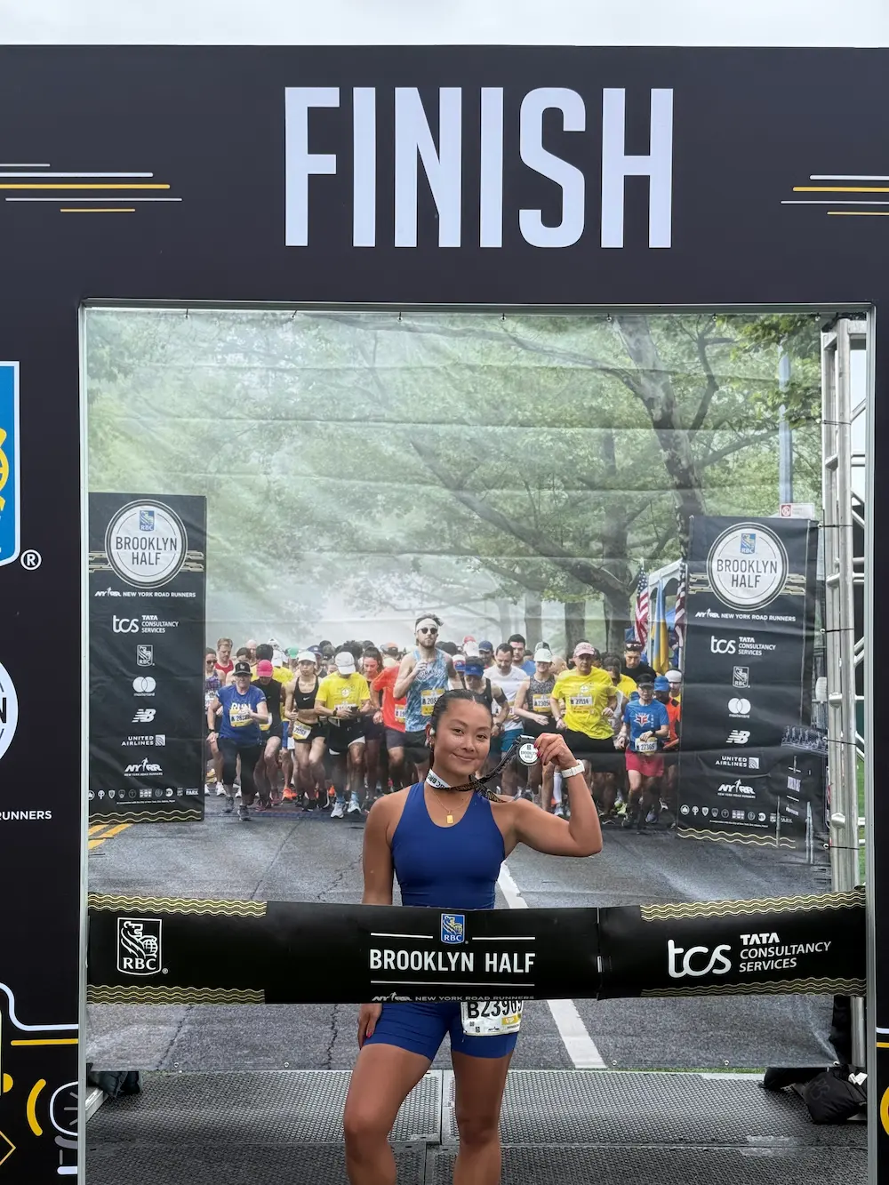 Runner celebrating at Brooklyn Half marathon finish line.