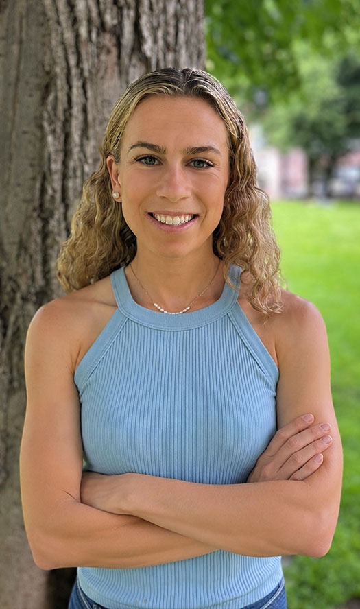 Smiling woman standing by tree in park