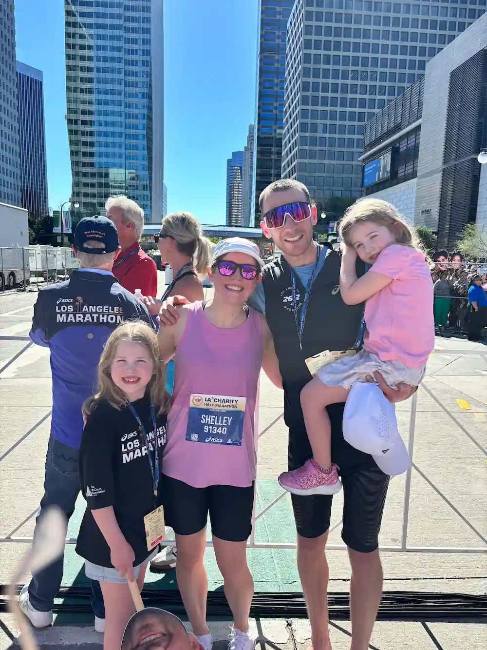 Family poses after Los Angeles Marathon downtown