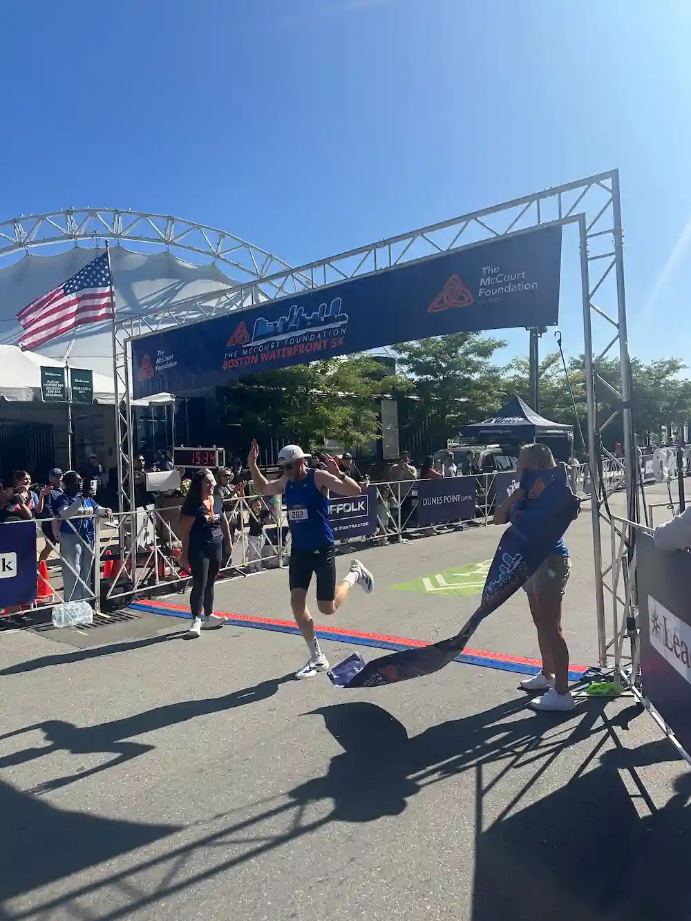 Runner crosses Boston Waterfront 5K finish line